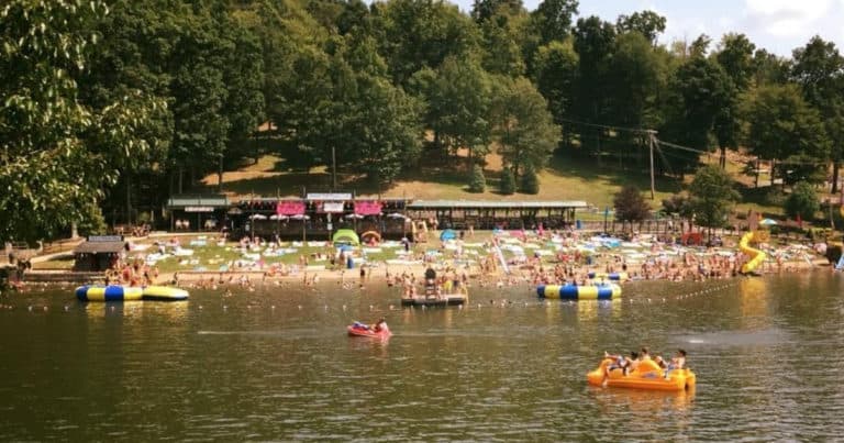 People swimming in lake at Tall Timbers Resort