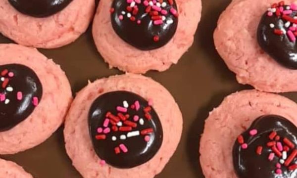 pink cookies with chocolate frosting and sprinkles