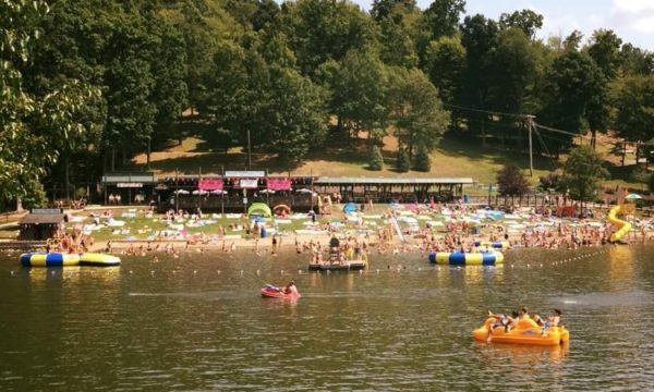 People swimming in lake at Tall Timbers Resort