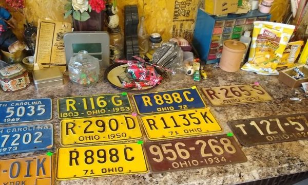 Vintage license plates on table at The Basement antique store
