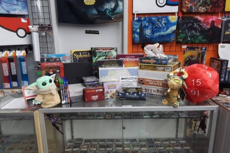 Video games, board games, kids toys, and trading cards on display in Mad Bros